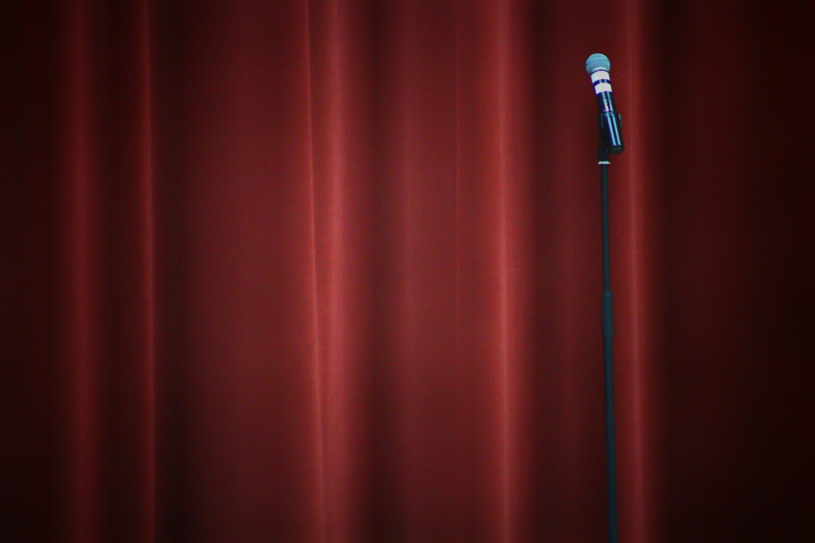 black microphone on red curtain