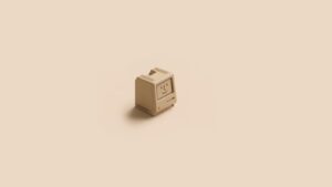 Retro beige computer model centered on a minimalist background.